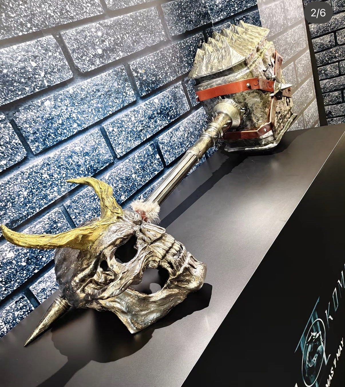 Two decorative metallic skull sculptures