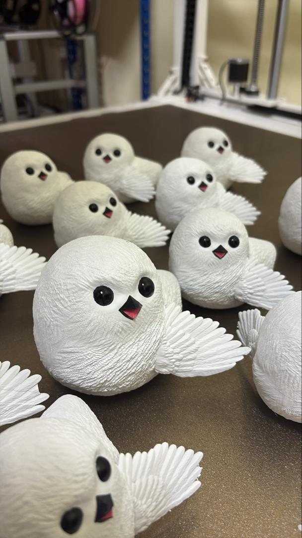 A group of small white owl characters